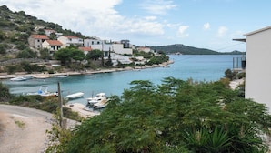 A coastal village with houses, boats, and a clear view of the sea. - Apartments Kate (Rogoznica)