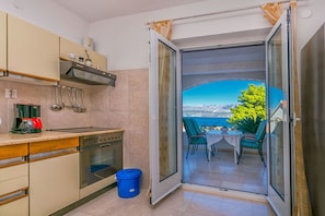 Apartment (A2) | Private kitchen | Fridge, microwave, oven, stovetop - Apartments Paco (Postira)