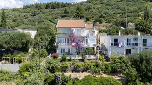 A multi-story residential building with balconies, surrounded by greenery and trees. - Apartments Lendic (Podgora)