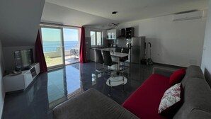 A modern apartment with a balcony, a kitchen, and a living area. - Apartments Dobrila (Jelsa)