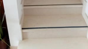 A staircase with a handrail and a light switch on the wall. - Apartment Milan (Trogir)