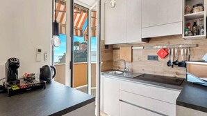 A modern kitchen with a built-in oven, a coffee maker, and a kettle on the counter. - La Scala Matta, Sea Lands (La Spezia)