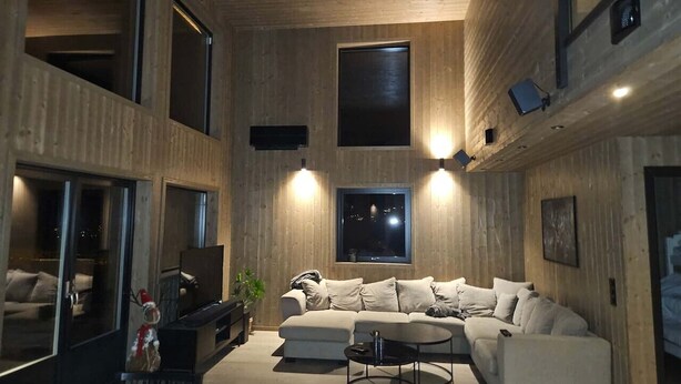 A modern living room with a sectional sofa, a coffee table, and a flat-screen TV. - Trysil Ski-in/out Apt, newly built (Trysil)