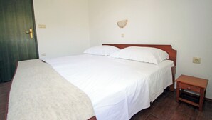 A bedroom with a bed, a bedside table, and a door. - House Anamaria (Posedarje)