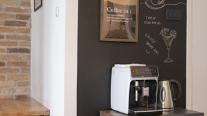 A cozy coffee bar area with a chalkboard displaying "Casa Hierta" and coffee-related drawings. - House Casa Huerta (Netretic)