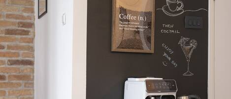 A cozy coffee bar area with a chalkboard displaying "Casa Hierta" and coffee-related drawings.