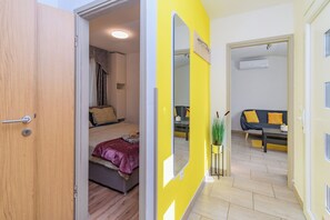 A room with a bed, a sofa, and a mirror. - House Nina (Pazin)
