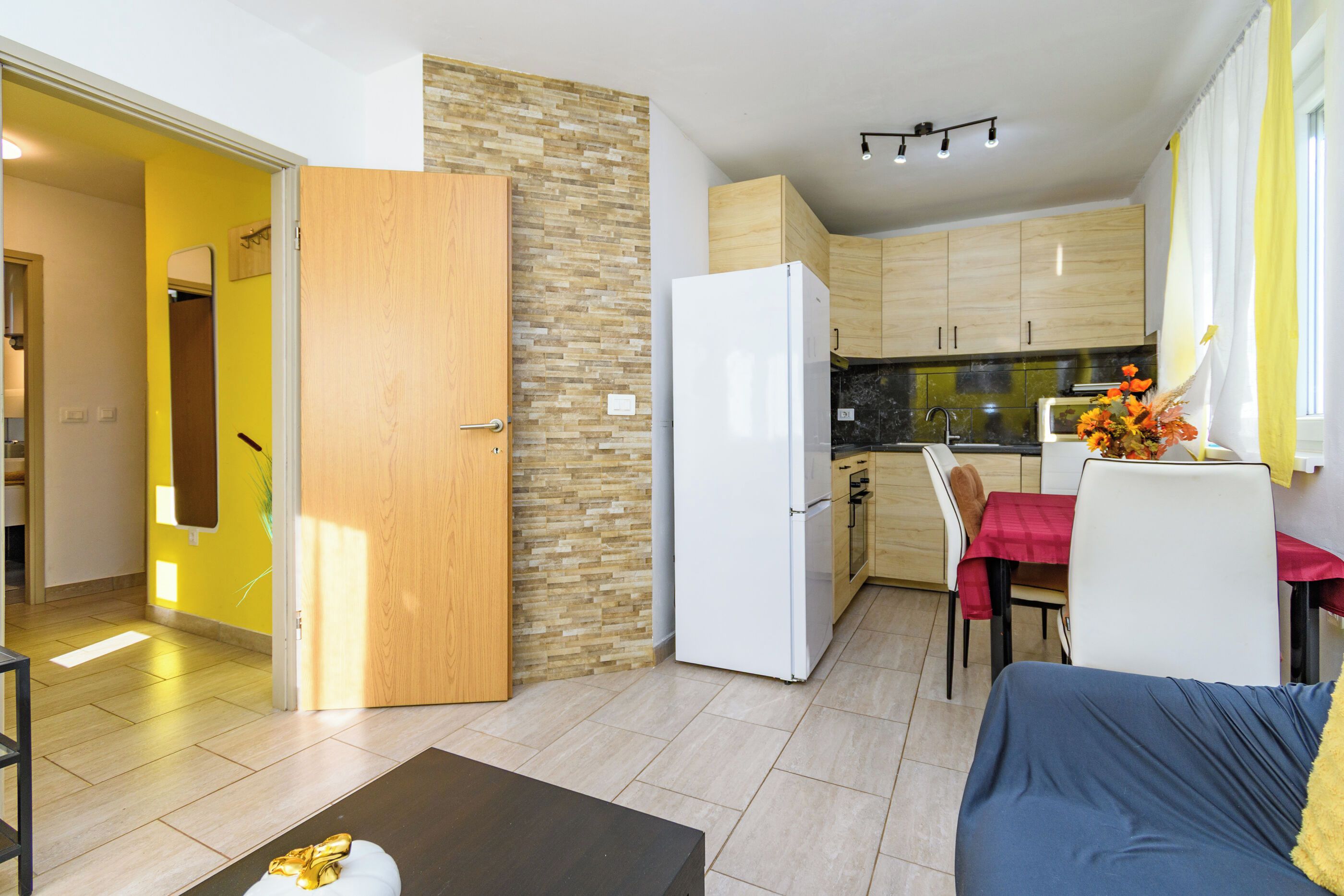 A compact living space with a kitchenette, a dining area, and a seating area.