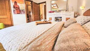 A bedroom with a bed, a dresser, a mirror, and a door leading to another room. - Apartment Bilice (Bilice)