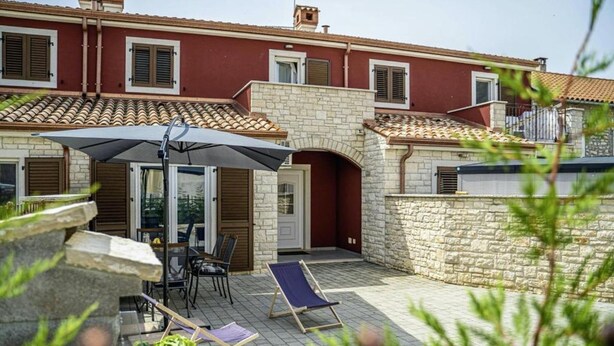 A villa with a stone facade, tiled roof, and a patio with outdoor furniture. - House Casa Maja (Brtonigla)