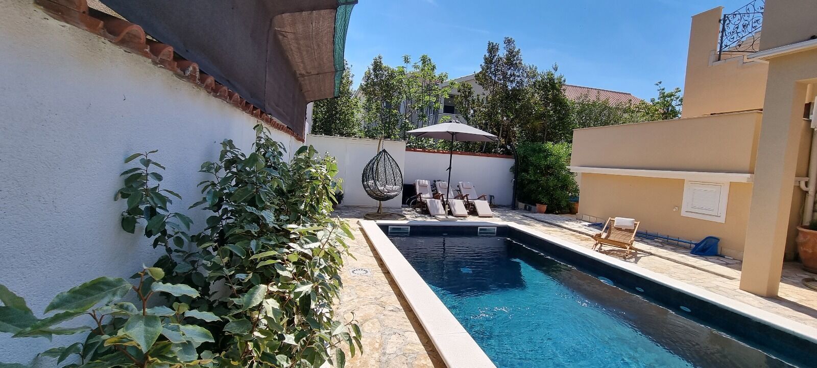 Outdoor pool, a heated pool, open open 24 hours a day, pool umbrellas