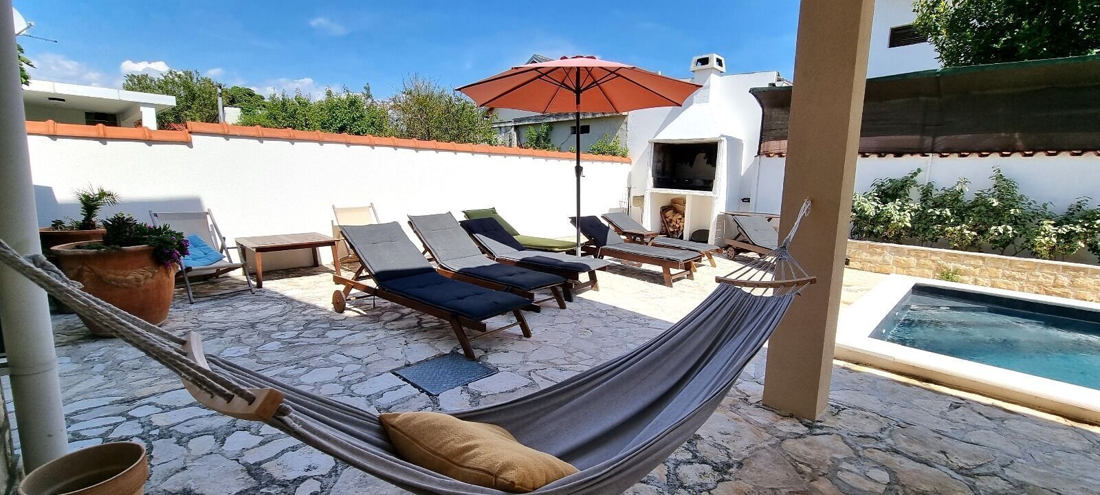 Outdoor pool, a heated pool, open open 24 hours, pool umbrellas