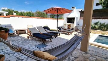 Outdoor pool, a heated pool, open open 24 hours, pool umbrellas