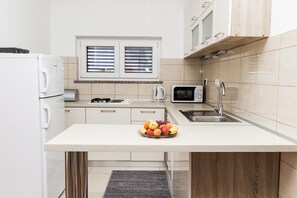 Apartment (A1) | Private kitchen | Fridge, microwave, stovetop, electric kettle - Apartments Vesna (Vodice)