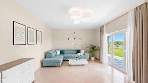 A modern living room with a sectional sofa, a coffee table, and a large window with curtains. - Apartment Vista Olivo (Brtonigla)