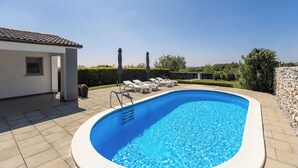 A swimming pool with a ladder, lounge chairs, and a small building with a window. - House Prenc (Sveti Petar u Sumi)