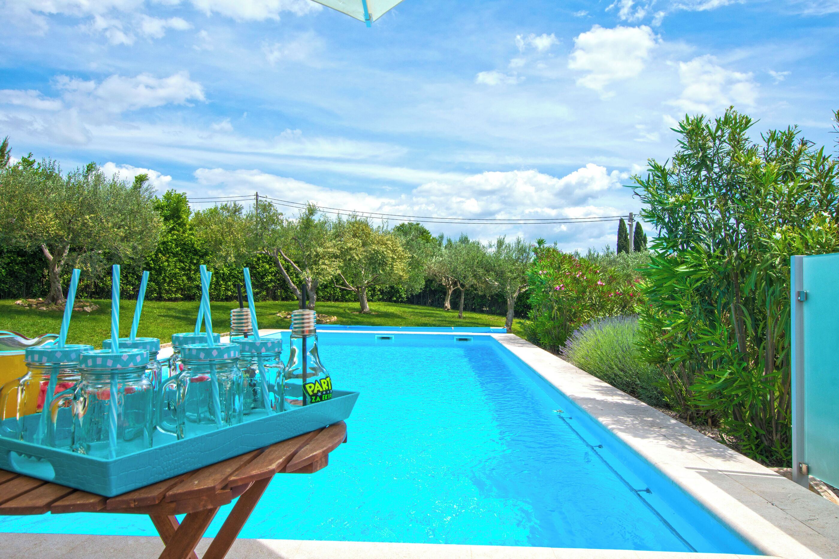 Outdoor pool, a heated pool, open open 24 hours a day, pool umbrellas