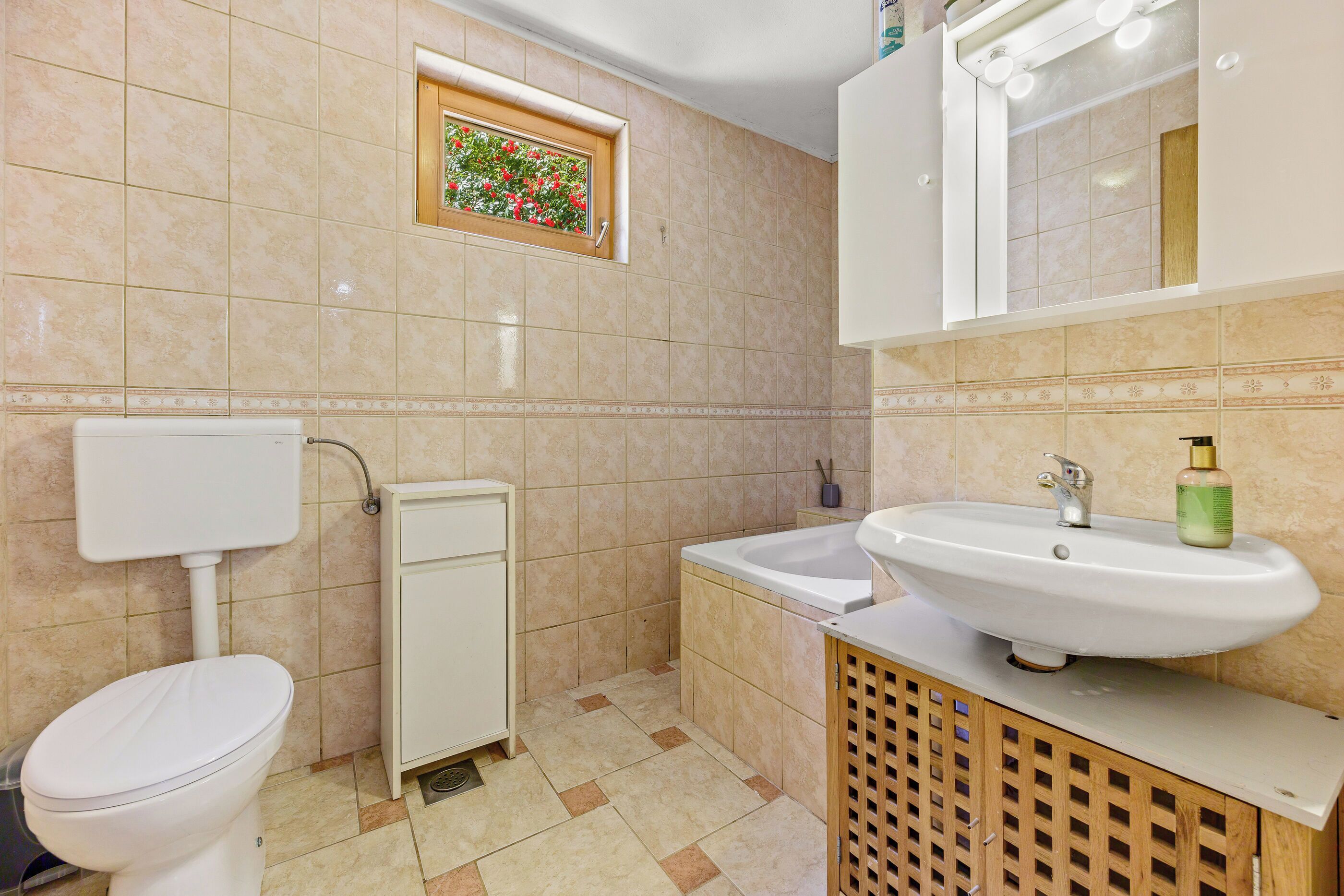 A bathroom with a toilet, a sink, and a shower.