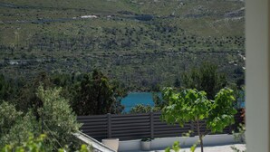 A terrace with a view of a lake and hills. - Apartments Jadranka (Sibenik)