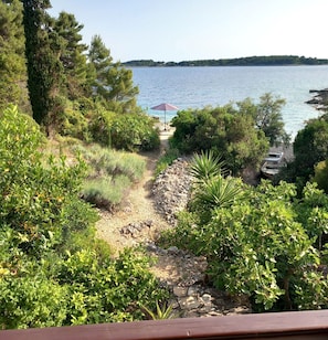 A view of a lake with a boat dock, surrounded by dense greenery and a clear sky. - House Garma (Blato)
