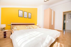 A bedroom with a bed, bedside table, and a wardrobe. - Apartments Milenko (Vodice)