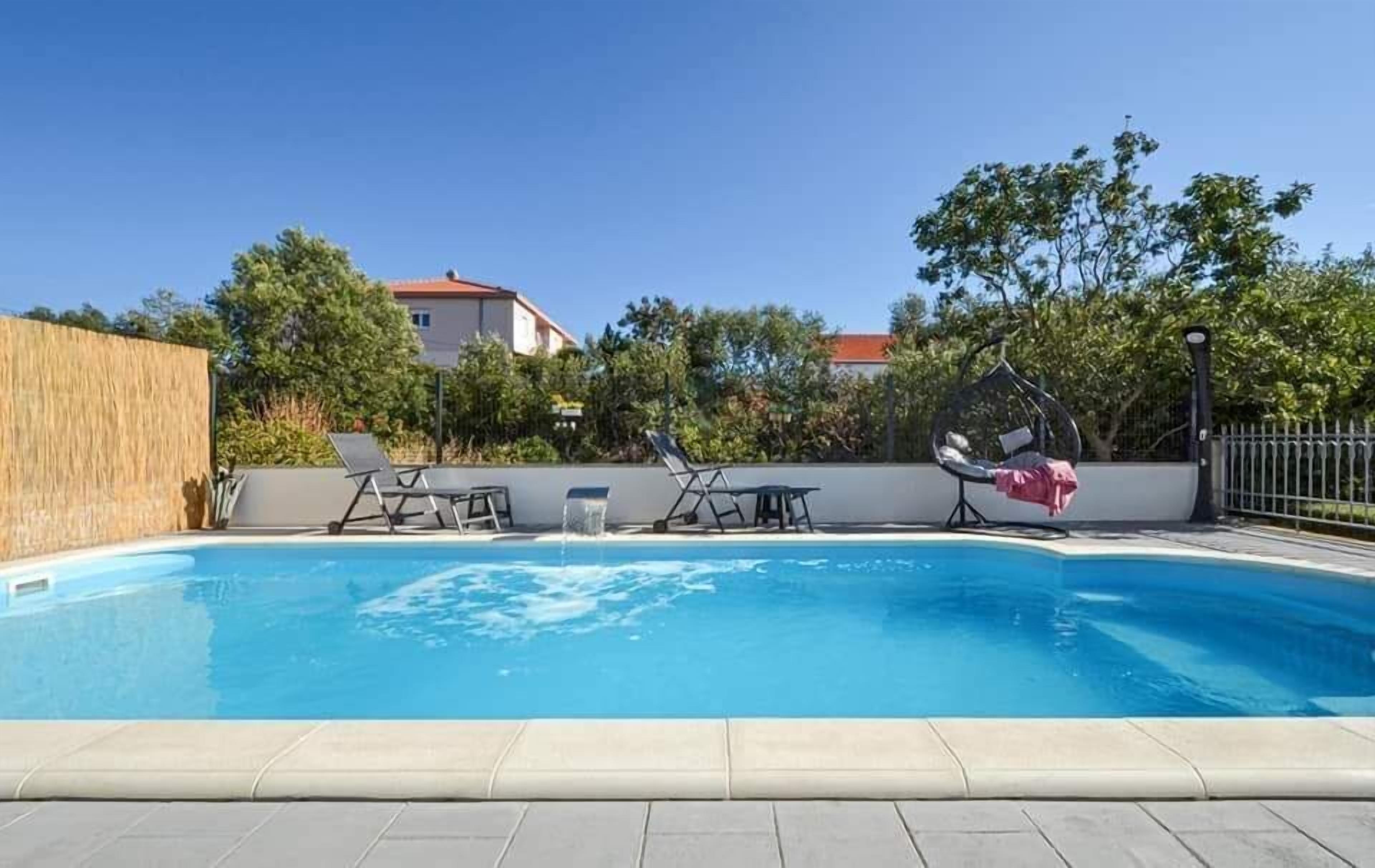 Outdoor pool, a heated pool, open open 24 hours a day, pool umbrellas