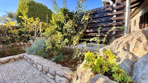 A garden with a variety of plants and a stone pathway. - Apartments Matosic (Omisalj)