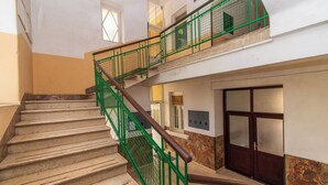 A multi-level interior with a staircase, a door, and a window. - Apartment Mandria (Opatija)