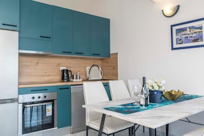 Apartment (A5) | Private kitchen | Fridge, microwave, stovetop, electric kettle - Apartments Beach House Blace (Slivno)