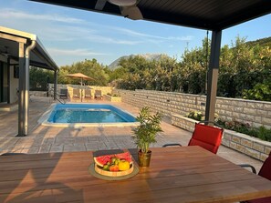 Outdoor pool, a heated pool, open open 24 hours, pool umbrellas