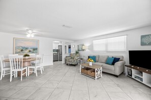 A modern living room with a sofa, coffee table, and TV stand. - Casa Blanca Villa - VA04 (Sarasota)