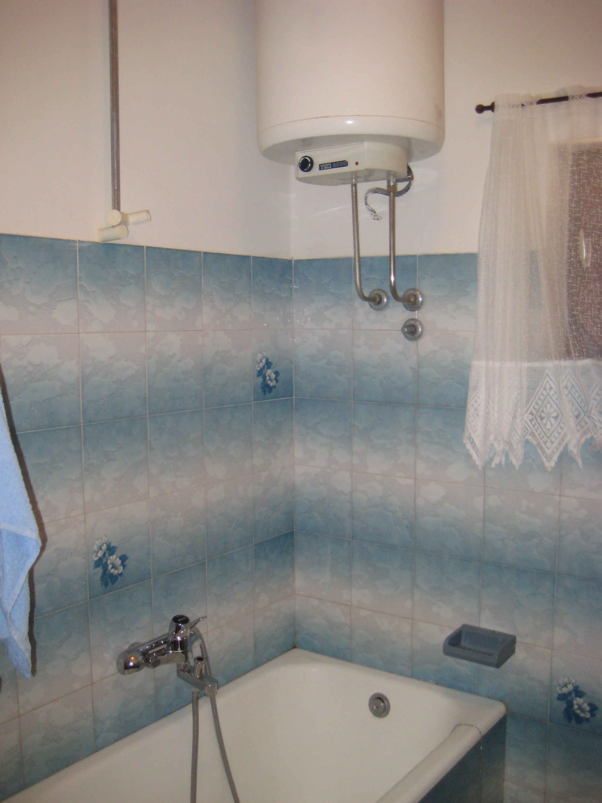 A bathroom with a bathtub, a shower, and a toilet.