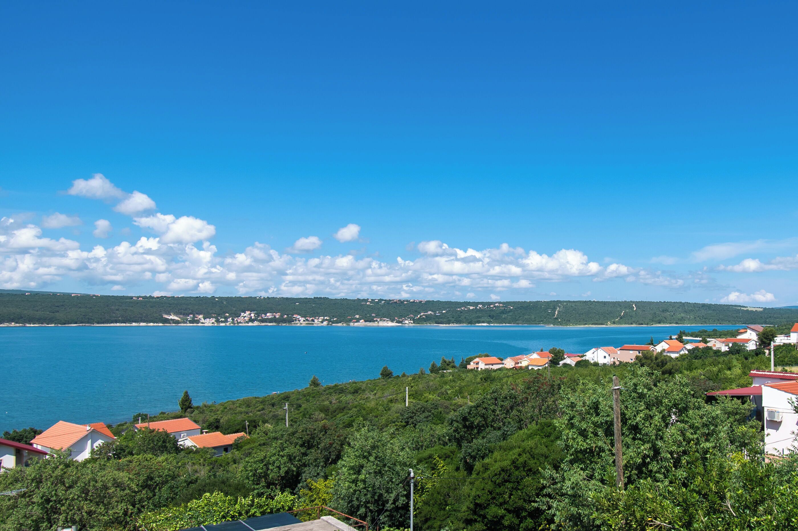 A coastal town with houses and a clear view of the sea.
