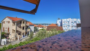 A residential area with multi-story buildings, balconies, and a clear blue sky. - Apartments Immortelle (Biograd na Moru)