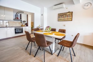 Apartment (A1) | Private kitchen | Fridge, stovetop, electric kettle, cookware/dishes/utensils
