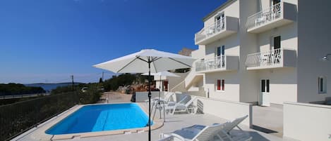 Outdoor pool, pool umbrellas, pool loungers