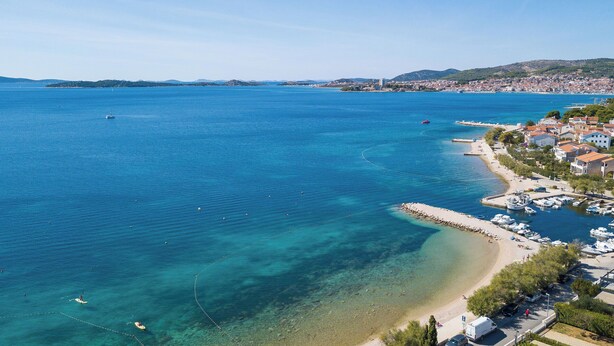 A coastal town with clear blue waters, a sandy beach, and a marina. - Apartment Zdravko (Vodice)
