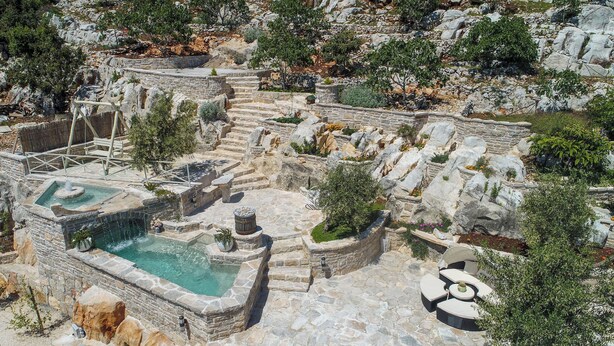 A stone bath area with a pool, steps, and seating. - House Ston (Orebic)