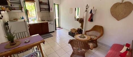 A compact living space with a kitchen, dining area, and seating area.