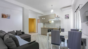 A modern apartment with a living area, kitchen, and dining space. - Apartment Danijel (Novi Vinodolski)