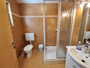 A bathroom with a toilet, a shower enclosure, and a sink. - House Sanleon (Vinodol)