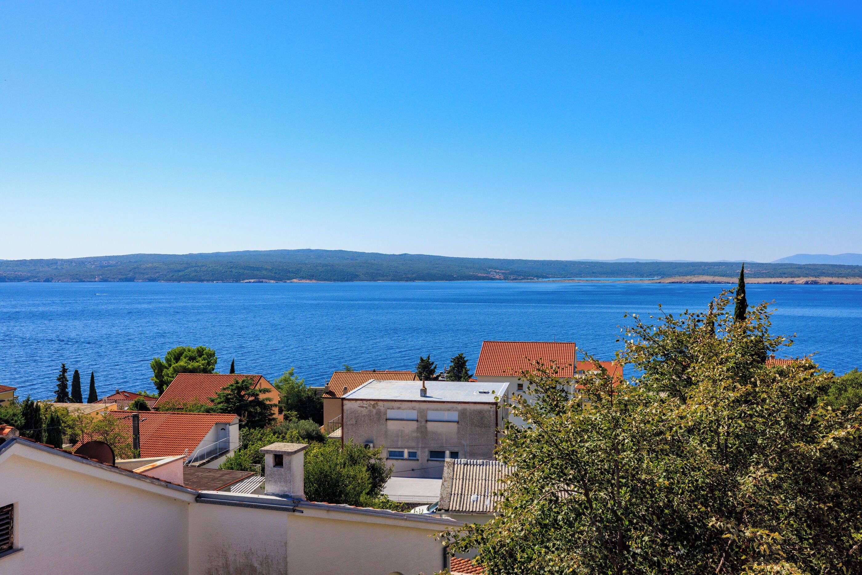 A coastal town with buildings and a clear view of the sea.