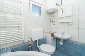 A bathroom with a toilet, sink, and bathtub. - Apartments Anita Tribunj (Tribunj)