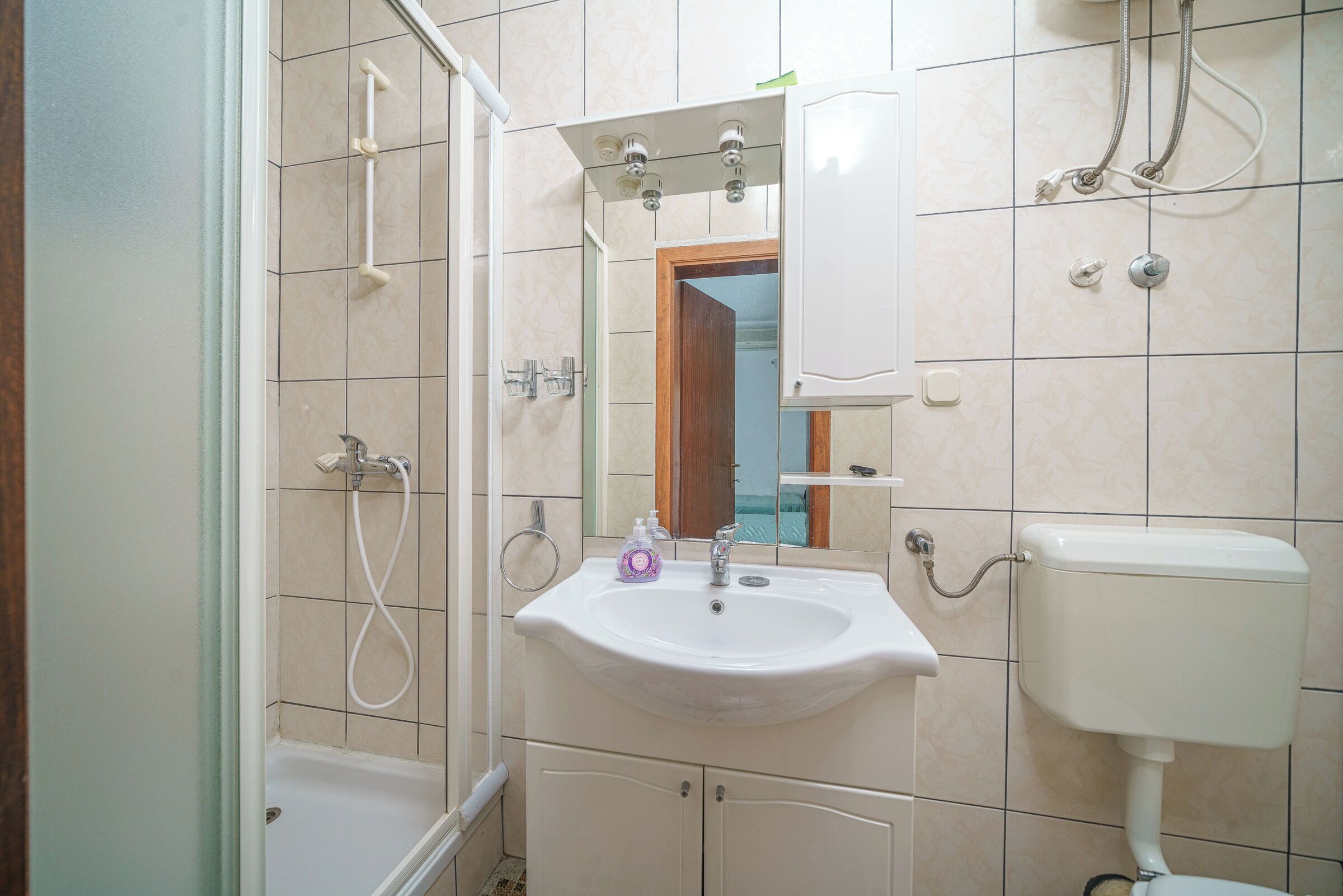 A bathroom with a bathtub, a sink, a toilet, and a shower.