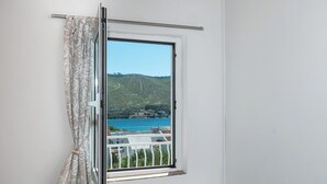 A window with a view of a body of water and hills. - Apartment Meri (Sibenik)