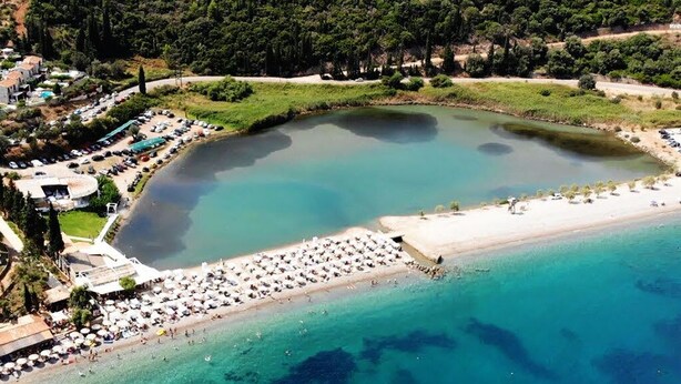 An aerial view of a coastal area with a beach, a marina, and a small island with buildings. - Seafront Villa Ciel with Private Pool in Nafpaktos (Platanitis)