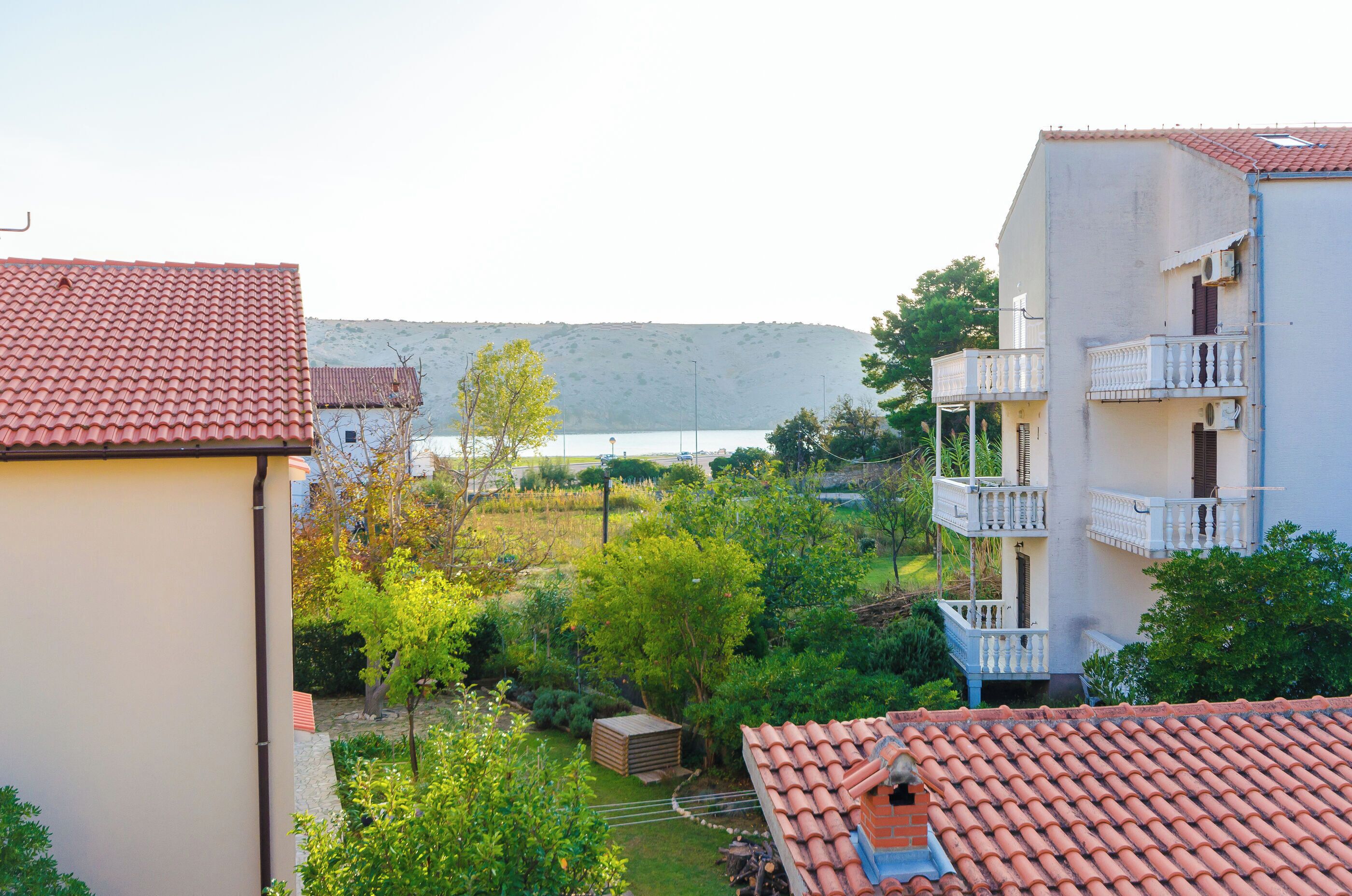 A residential area with a view of a lake and hills.