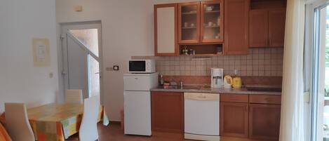 Apartment (A2) | Private kitchen | Fridge, microwave, stovetop, dishwasher