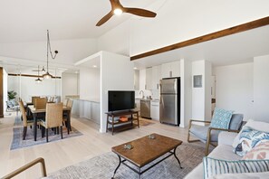 A modern living room with a dining area, kitchen, and a ceiling fan. - Beautifully Remodeled 2 Bedroom/ 2 Bath- Stunning Views - Kihei Holiday #315 (Kihei, Maui)