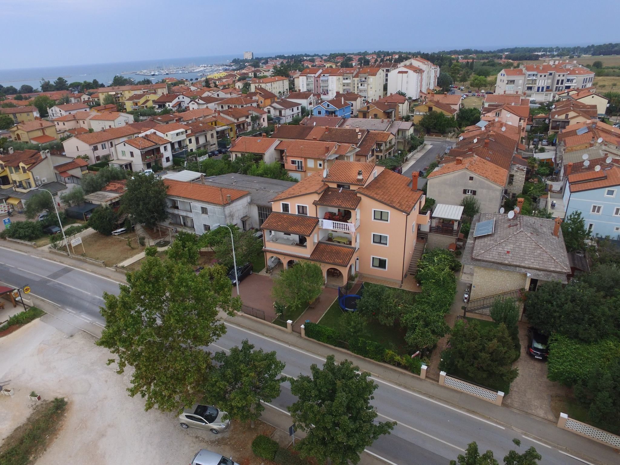 A residential area with a mix of single and multi-story buildings, featuring a variety of roof styles and colors.